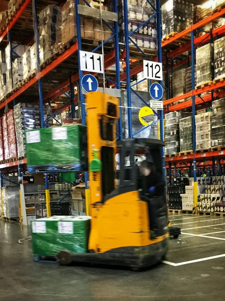 A forklift moving pallets in a dispatch bay
