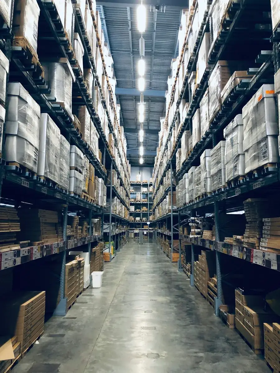 A warehouse aisle with racks of stock